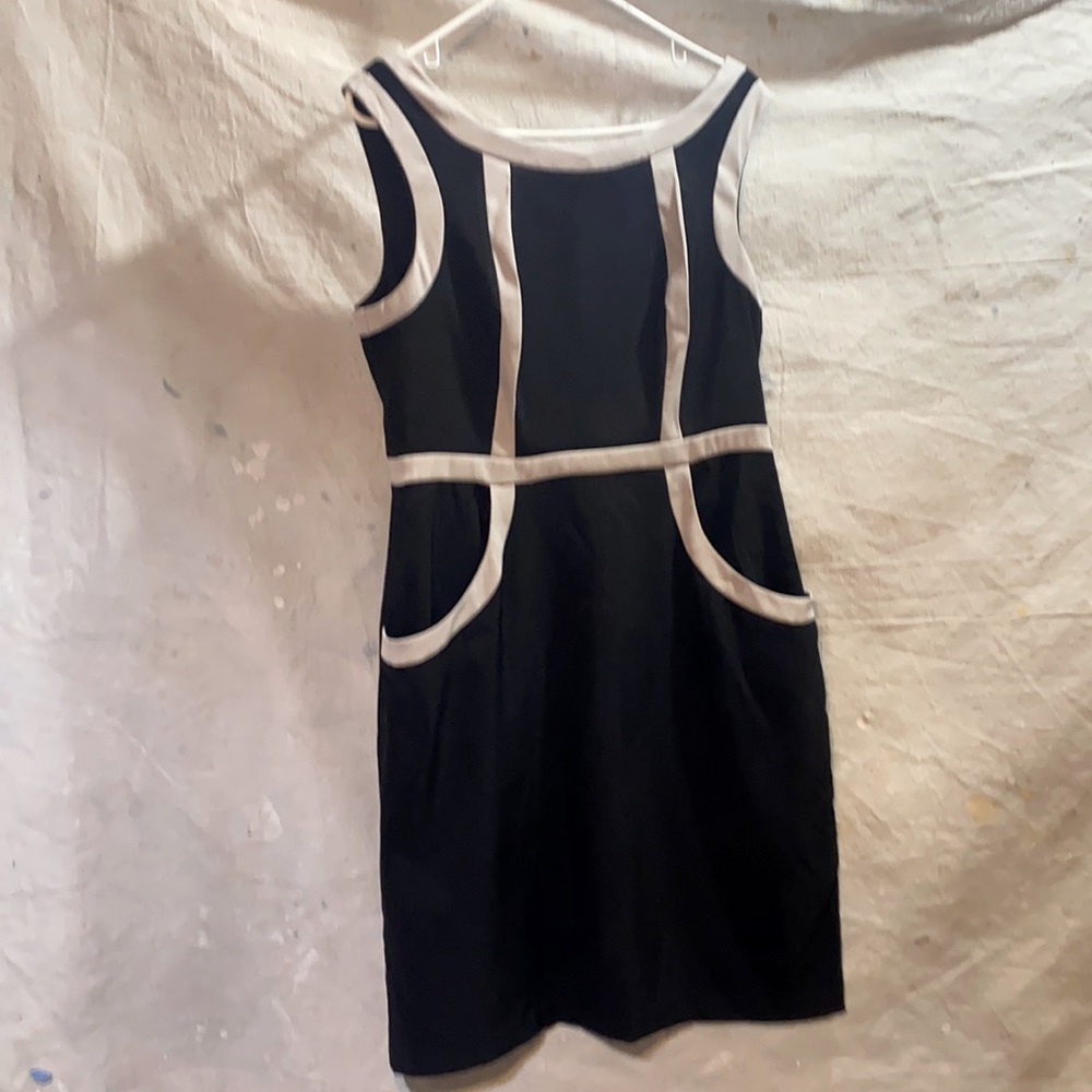 Black dress with white trim. Good condition size 14 with small slit in back